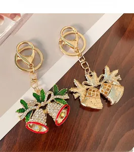 Detail of Christmas bell keychain featuring red and green enamel and crystal inlay