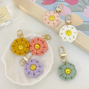 Handmade crochet flower keychain with smiley face in six vibrant colors and gold lobster clasp