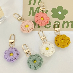 Handmade crochet flower keychains with smiley faces and gold lobster clasps in six colors