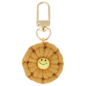 Handmade crochet flower keychain with a yellow smiley face charm and golden metal clip