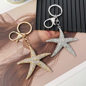 Porte-clés étoile de mer étincelant avec strass blancs en alliage doré et argenté