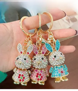Detailed view of three bunny keychains with sparkling colorful rhinestones and gold clasp