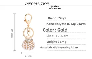 Detailed view of mini purse keychain with white pearls and sparkling rhinestones