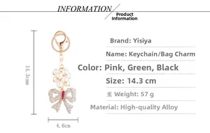 Detail view of pearl bow keychain with dimensions 14.3cm x 4.6cm on white background