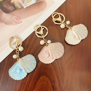 Marine shell keychain set with rhinestones and pearls on gold-toned alloy base