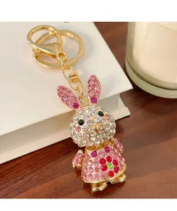 Detail of a sparkling rhinestone rabbit keychain with pink floral pattern and gold clasp