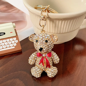 Sparkling crystal teddy bear keychain with a red enamel bow tie on a gold metal ring