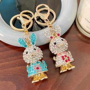 Cute rhinestone bunny keychains in pink and blue with gold plating and floral details