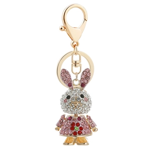 Sparkling pink rabbit keychain with rhinestones and gold plating on white background