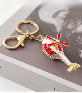 Detail of red and white enamel helicopter keychain with sparkling crystal rhinestones
