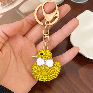 Sparkly yellow rhinestone duck keychain with white bow and golden lobster clasp