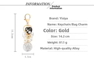Detail view of gold keychain with pearl bead, crystal ball and number 5 heart charm