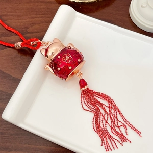 Golden Chinese Lucky Cat car hanging ornament with red enamel details and silk tassels