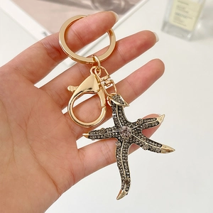 Starfish keychain with sparkling grey diamonds and gold metal lobster clasp for bags