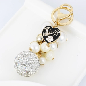 Elegant gold keychain with heart charm, white pearls and sparkling rhinestone ball accessory