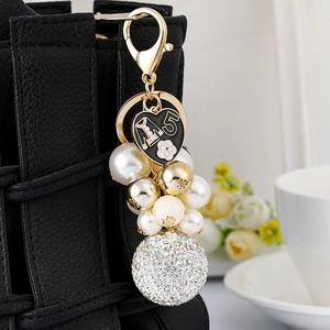 Elegant gold keychain with pearl bead strands, black heart charm and rhinestone sphere