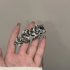 Elegant tweed hair clip in black and white with gold metallic thread detail