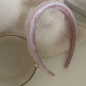 Elegant lavender velvet pearl headband with gold accent on soft knit background