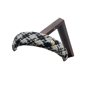 Elegant black and white houndstooth tweed padded headband with a gold metal button