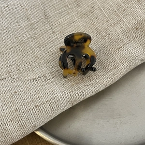 Detail of tortoiseshell acetate mini hair claw clip featuring France Handmade engraving