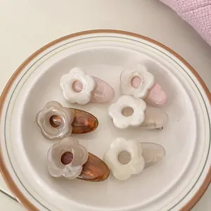 Set of 6 minimalist acetate flower hair clips in cream, pink, and amber floral designs