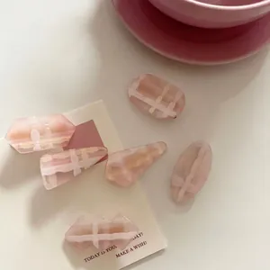 5-piece set of pink geometric acrylic hair clips in oval and rectangular shapes
