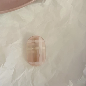 Close-up of a pink jelly acrylic hair clip with a sweet white checkered pattern finish