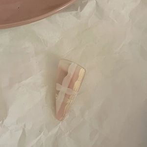 Close-up of pink and white marble hair clip with elegant gold foil flakes