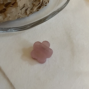 Gros plan d'une mini pince à cheveux fleur rose translucide en résine d'acétate