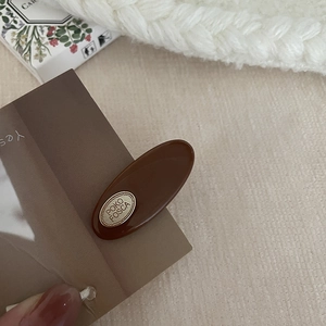 Latte brown oval hair clip with gold metal plaque and resin finish for women