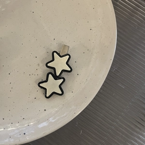 Y2K star hair clip with black and white stars on a silver metal duckbill base