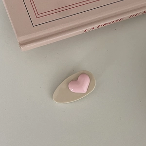 Cute cream-colored hair clip with a pink 3D heart design and resin base