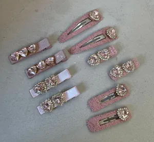 Close-up of Lolita pink heart rhinestone hair clips with delicate lace and ribbon textures