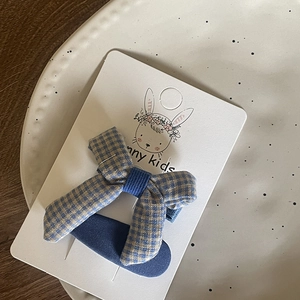 Blue and yellow plaid fabric bow hair clip for girls on elegant decorative plate