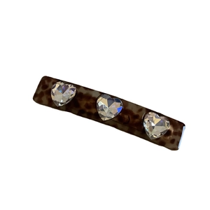 Tortoiseshell acetate hair clip with three sparkling heart-shaped crystals