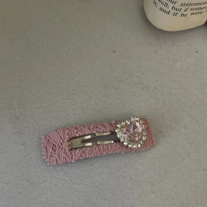 Close-up of Lolita pink lace hair clip with a sparkling heart gemstone and rhinestones