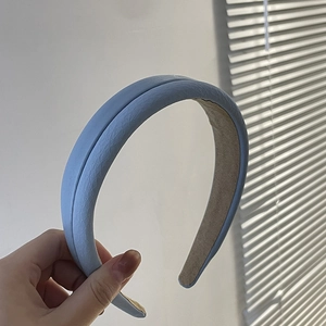 Detail of light blue faux leather headband with soft non-slip khaki suede lining