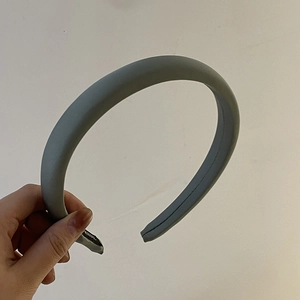 Detailed macro view of padded morandi grey headband with premium smooth satin finish