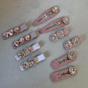 Pink Lolita heart rhinestone hair clips with lace detailing on a grey background