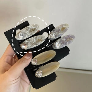 Acetate hair clips set with heart crystal and gold handmade lettering on display card