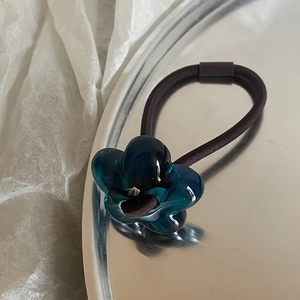 Cute minimalist floral hair tie with blue translucent resin flower and dark brown band