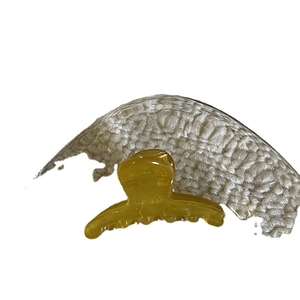 Minimalist translucent amber yellow mini hair claw clip with a sleek resin finish