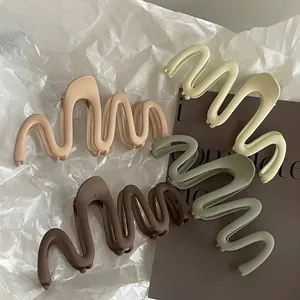 Set of 4 large matte wavy hair claw clips in neutral earthy tones for women