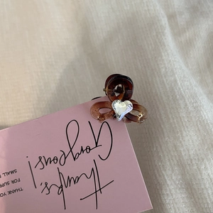 Mini heart rhinestone claw clip in tortoiseshell finish for elegant hair styling
