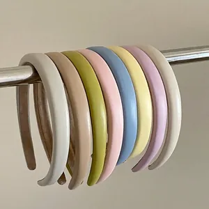 Set of 8 colorful matte leather padded headbands in cream, green, and pastel shades
