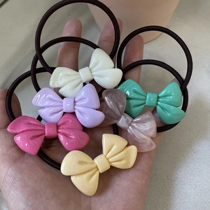 Set of 6 colorful cream-tone bow hair ties featuring glossy resin and elastic bands