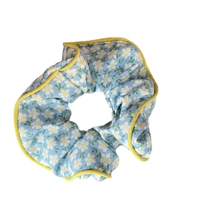 Floral scrunchie in light blue with white flower patterns and yellow contrast edges