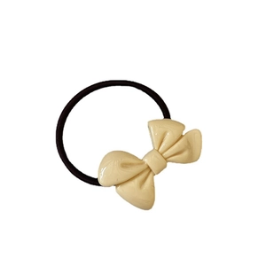 Creamy bow hair tie with elastic black band for women in a minimalist sweet style