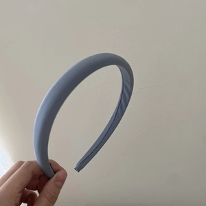 Minimalist light blue padded headband with matte fabric finish and subtle stitching