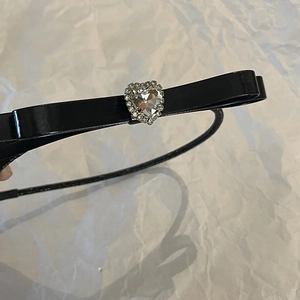 Elegant black bow headband for women featuring a sparkling heart-shaped crystal center